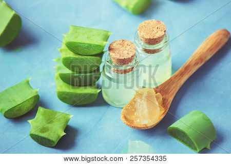 Aloe Vera Extract In A Small Bottle And Pieces On The Table. Selective Focus.