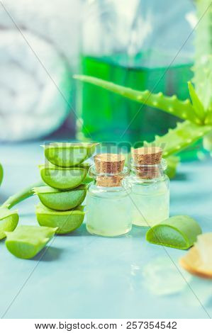 Aloe Vera Extract In A Small Bottle And Pieces On The Table. Selective Focus.