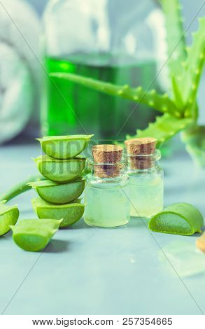 Aloe Vera Extract In A Small Bottle And Pieces On The Table. Selective Focus.