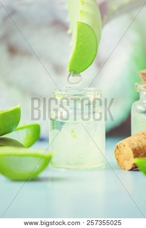 Aloe Vera Extract In A Small Bottle And Pieces On The Table. Selective Focus.