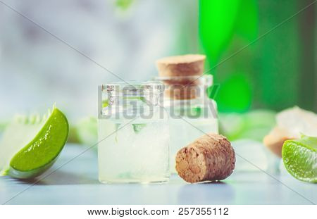 Aloe Vera Extract In A Small Bottle And Pieces On The Table. Selective Focus.