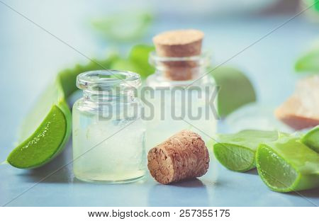 Aloe Vera Extract In A Small Bottle And Pieces On The Table. Selective Focus.