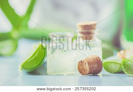Aloe Vera Extract In A Small Bottle And Pieces On The Table. Selective Focus.