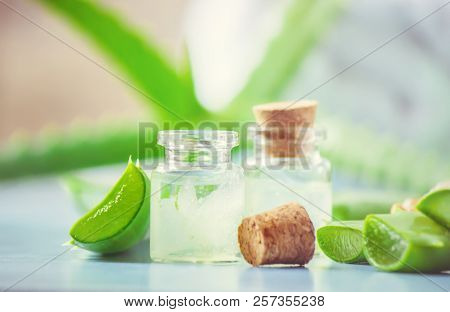 Aloe Vera Extract In A Small Bottle And Pieces On The Table. Selective Focus.