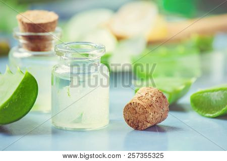 Aloe Vera Extract In A Small Bottle And Pieces On The Table. Selective Focus.
