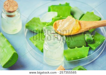 Aloe Vera Extract In A Small Bottle And Pieces On The Table. Selective Focus.