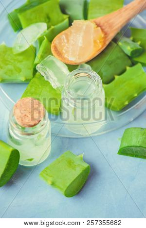 Aloe Vera Extract In A Small Bottle And Pieces On The Table. Selective Focus.