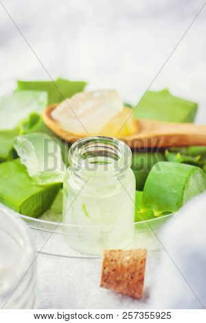 Aloe Vera Extract In A Small Bottle And Pieces On The Table. Selective Focus.