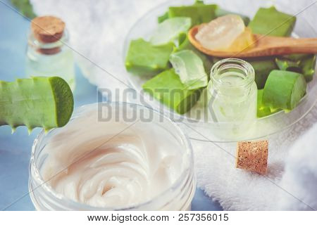 Aloe Vera Extract In A Small Bottle And Pieces On The Table. Selective Focus.