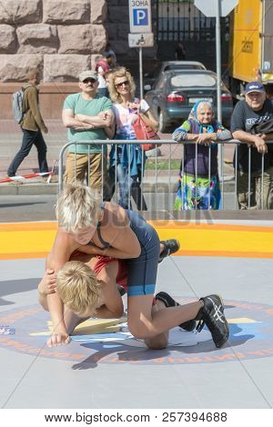 Ukraine, Kiev, Ukraine 09.09.2018 Boys On Street Tatami Engaged In Greek Wrestling. Vertical Photo