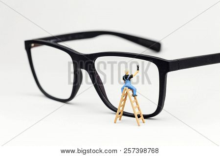 Miniature Man On A Ladder Cleaning Glasses