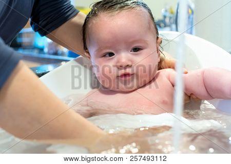 Baby Boy Taking A Bath In A Little Bath Tub