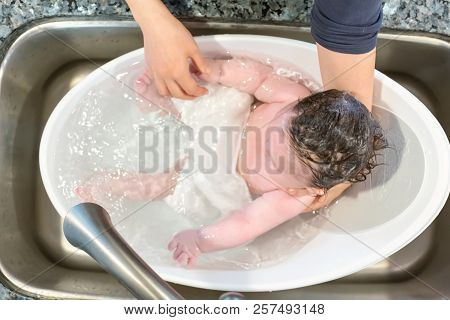 Baby Boy Taking A Bath In A Little Bath Tub