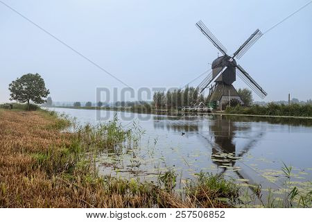 On The Water There Are Several Windmills In Kinderdijk In Holland