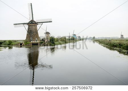 On The Water There Are Several Windmills In Kinderdijk In Holland