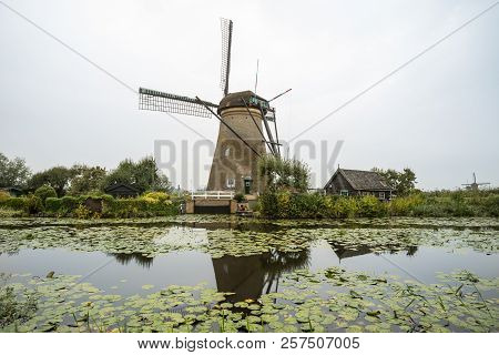 On The Water There Are Several Windmills In Kinderdijk In Holland