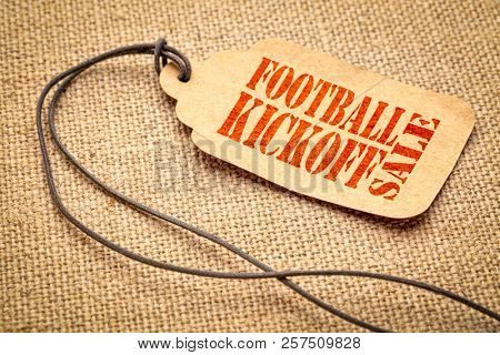 Football Kickoff Sale sign - a paper price tag with a twine iagainst burlap canvas