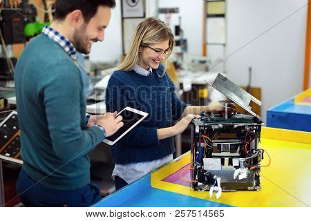 Young Attractive Students Of Mechatronics Working On Project