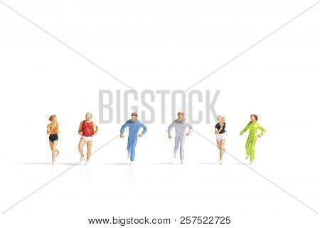 Miniature People Running On White Background , Healthy Lifestyle And Sport Concepts.