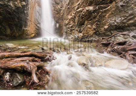 Autumn Waterfall With Rocks And Leaves In Troodos Mountains In Cyprus