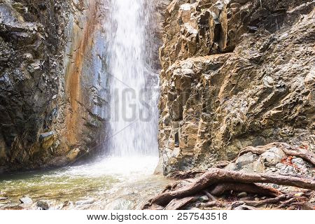 Autumn Waterfall With Rocks And Leaves In Troodos Mountains In Cyprus
