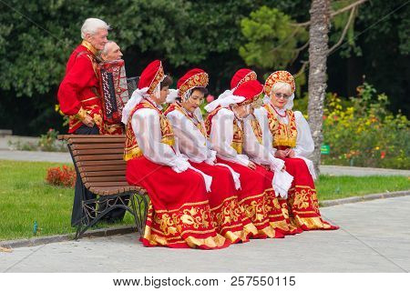 Yalta, Crimea - October 20, 2017: Elderly People In Red Folk Costumes Posing For Photography.