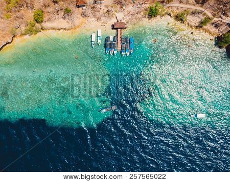 Boats At The Pier In Ocean On Menjangan Island. Aerial View.