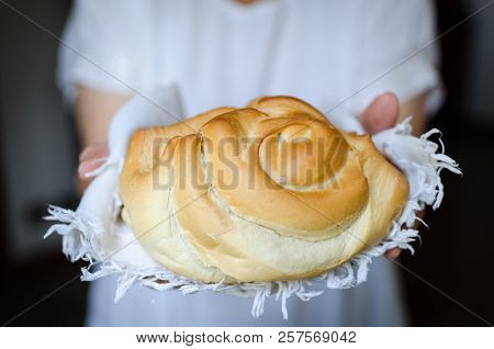Round Bread In Womans Hands. Baker Holding A Beautiful Freshly Baked Warm Bread. Rustic Vintage Styl
