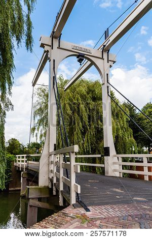 Beautiful Wooden Bridge Over Canal In The Netherlands