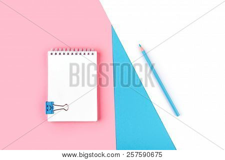 Top View Of Blank Notebook On Colorful Background Pink Blue Whitewith Copy Space.