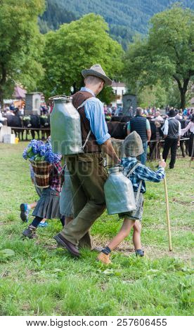 Dad And Son Wear A Characteristic Dress Of Pastors Of The Past