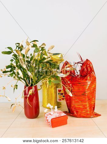 Gifts In Red And Silver Package With Mistletoe