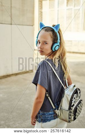 Cute Teen Girl With Backback And Headphones