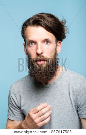 Omg Unbelievable Shock. Speechless Dumbstruck Man. Portrait Of A Young Bearded Guy On Blue Backgroun