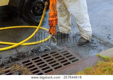 A Hydrohammer Removes An Old Paving Repair Of Roads In The City