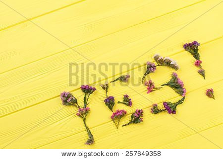 Statice Flowers Forming Statice Flowers. Top View. Yellow Wooden Table Surface Background.