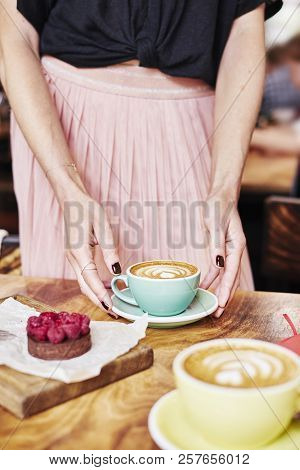 Cup Of Coffee Latte And Sweet Pastry On Wooden Table In Woman Hands. Gentle Romantic Mood, Girl Wear