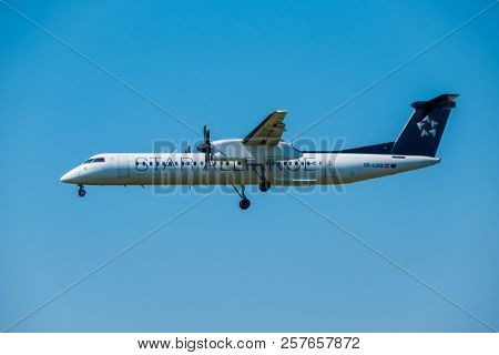 Zurich, Switzerland - July 19, 2018: Star alliance airlines Bomardier Dash 8 Q400 airplane preparing for landing at day time in international airport