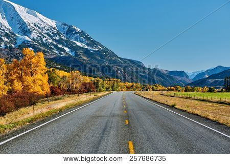 Highway in Colorado Rocky Mountains at autumn, USA. Mount Sopris landscape.