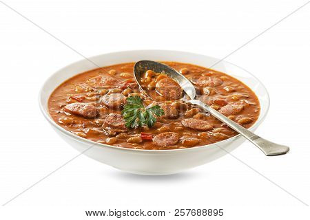 Baked Beans Stew With Tomato Sauce And Sausage With Herbs Isolated On White