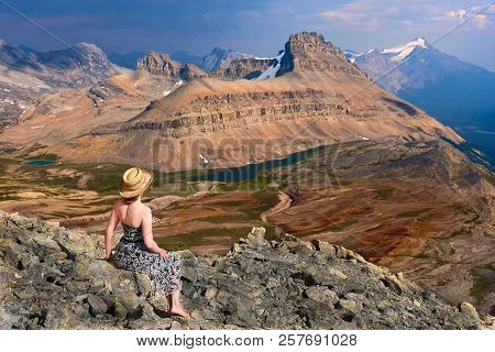 Inner Peace And Mindfulness. Woman On Mountain Top Meditating And Realxing. View Of Dolomite Mountai
