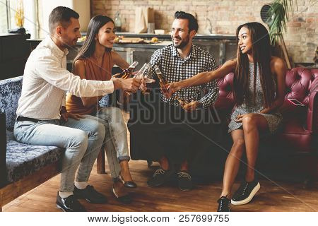 Spending Great Time With Best Friends. Group Of Cheerful Young People Enjoying Food And Drinks While