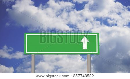 Green Road Sign With Arrow On Sky Background With Clouds
