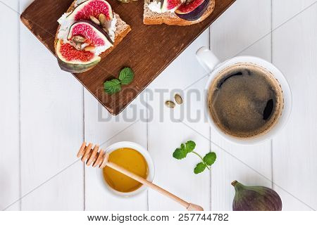 Coffee And Delecious Ricotta Toast With Figs On The White Table