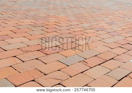 Pavement Of Red, Dark Red And Orange Bricks At Summer Day
