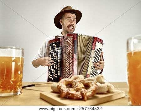Man In Traditional Bavarian Clothes Playing Accordion. Germany, Bavaria, Upper Bavaria. The Young Ha