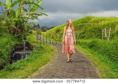 Young Woman Traveler On Beautiful Jatiluwih Rice Terraces Against The Background Of Famous Volcanoes