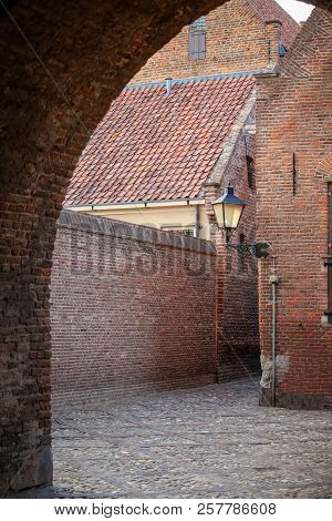 The Entrance Through An Authentic Monumental City Gate To A Characteristic Medieval Town. Remains Of