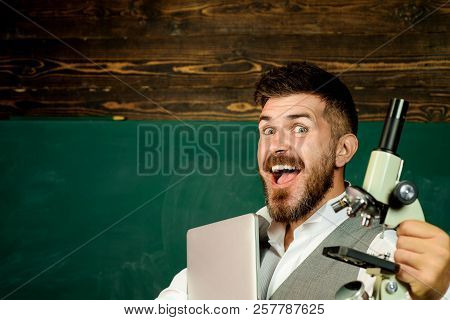 Back To School Concept. Educator, Chemistry Or Biology Teacher With Computer And Microscope. Chemist