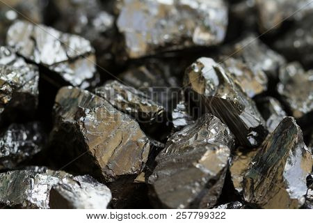 Black Coal Mine Close-up With Soft Focus. Anthracite Coal Bar On Dark Background